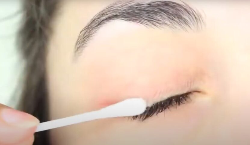 applying coconut oil on lashes